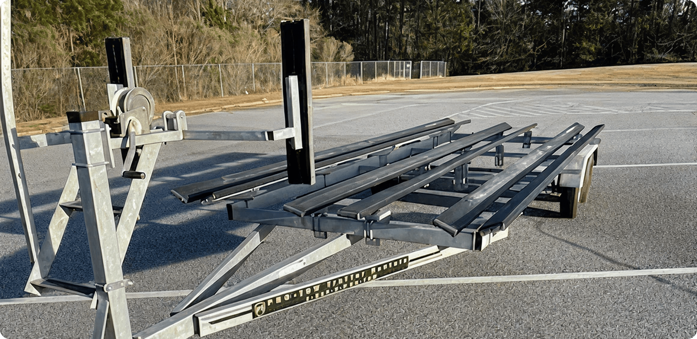 Metal trailer with winch in parking area